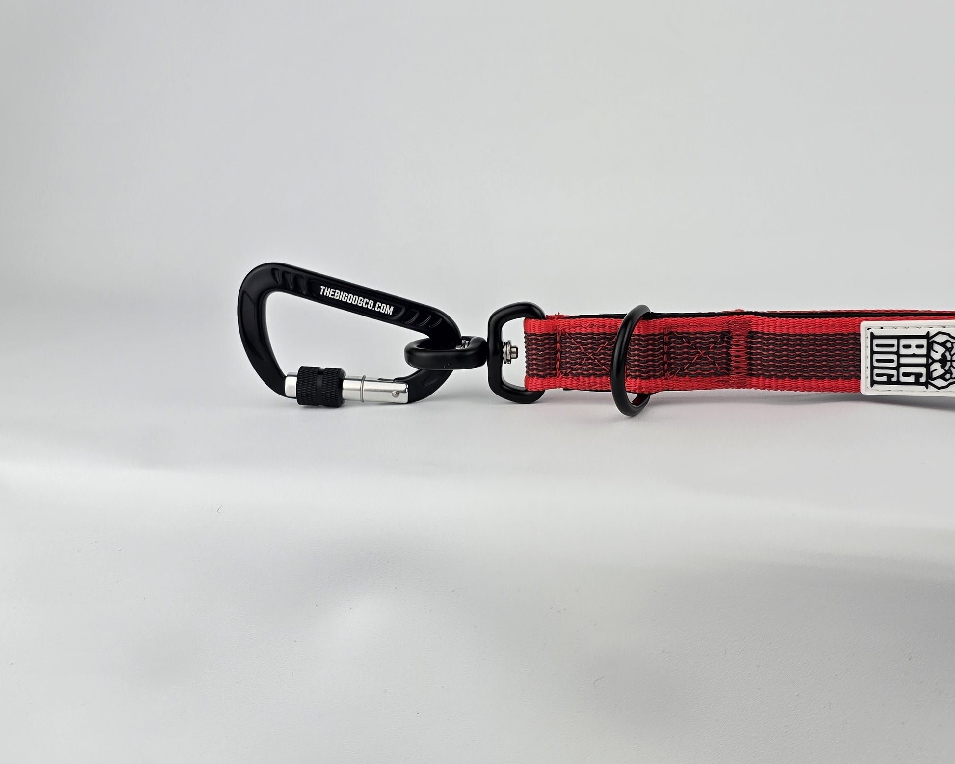 Red and black dog handle with a The Big Dog Company logo. Neoprene, rubber, nylon. Heavy duty, high quality. 