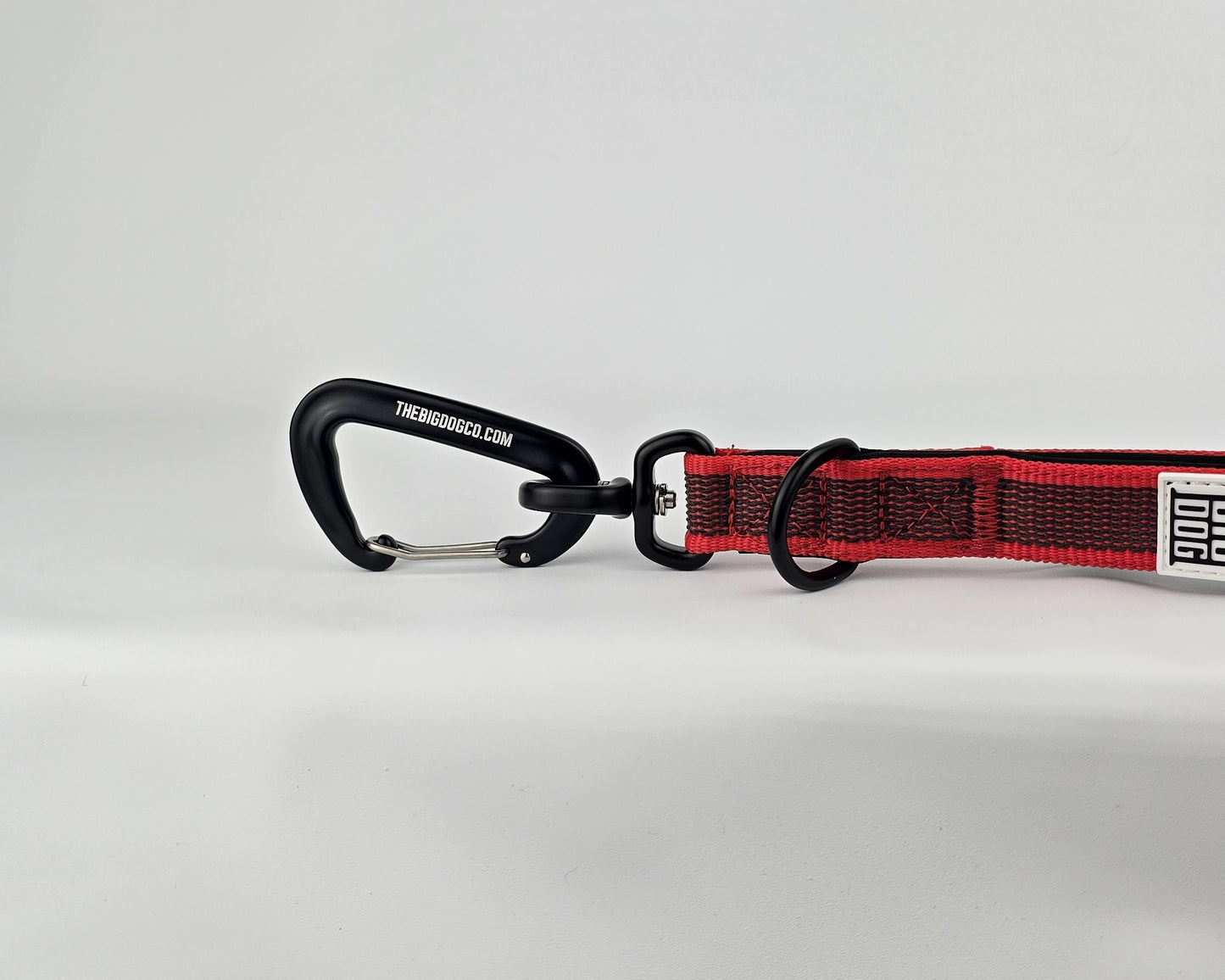 Red and black dog handle with a The Big Dog Company logo. Neoprene, rubber, nylon. Heavy duty, high quality. 