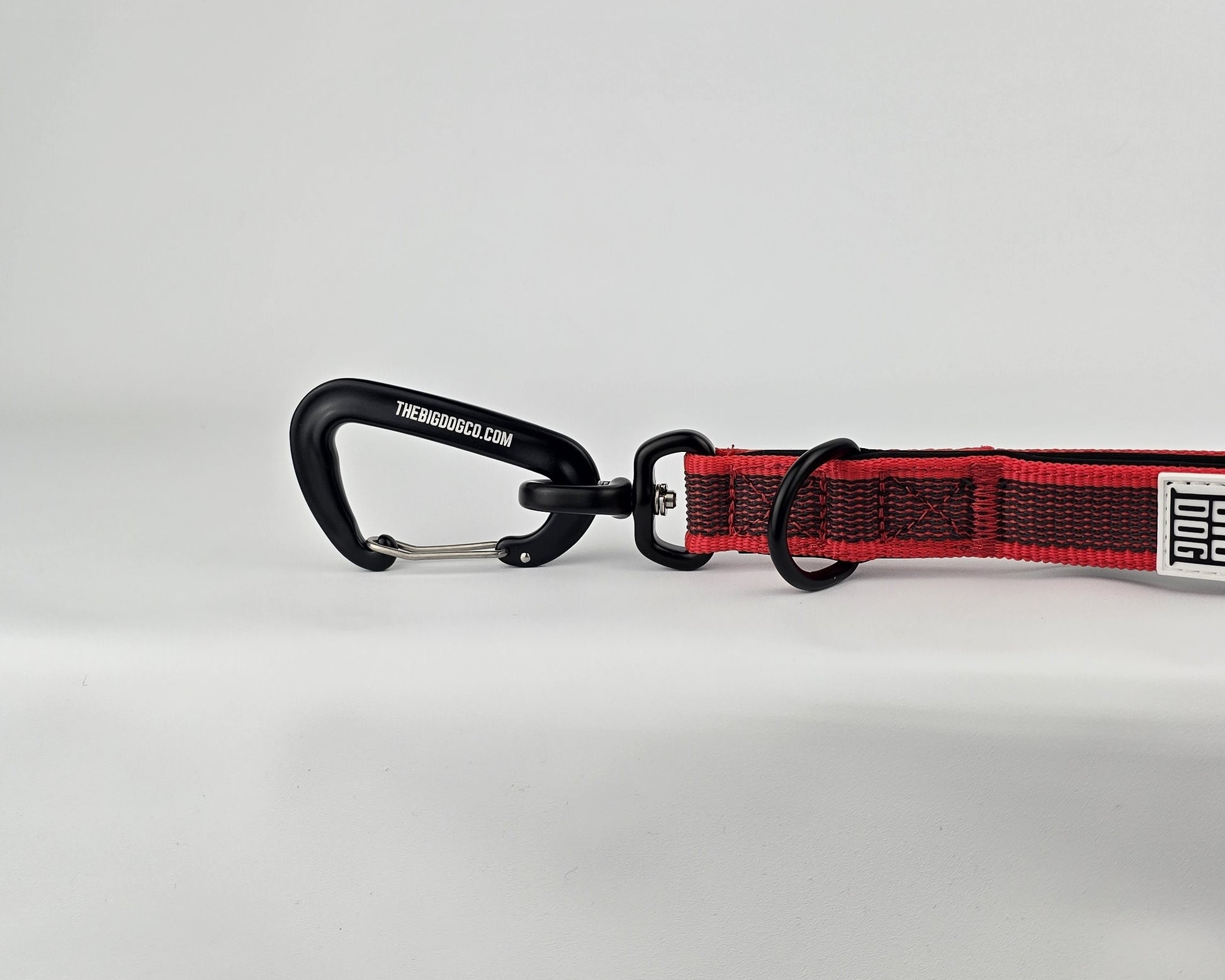 Red and black dog handle with a The Big Dog Company logo. Neoprene, rubber, nylon. Heavy duty, high quality. 