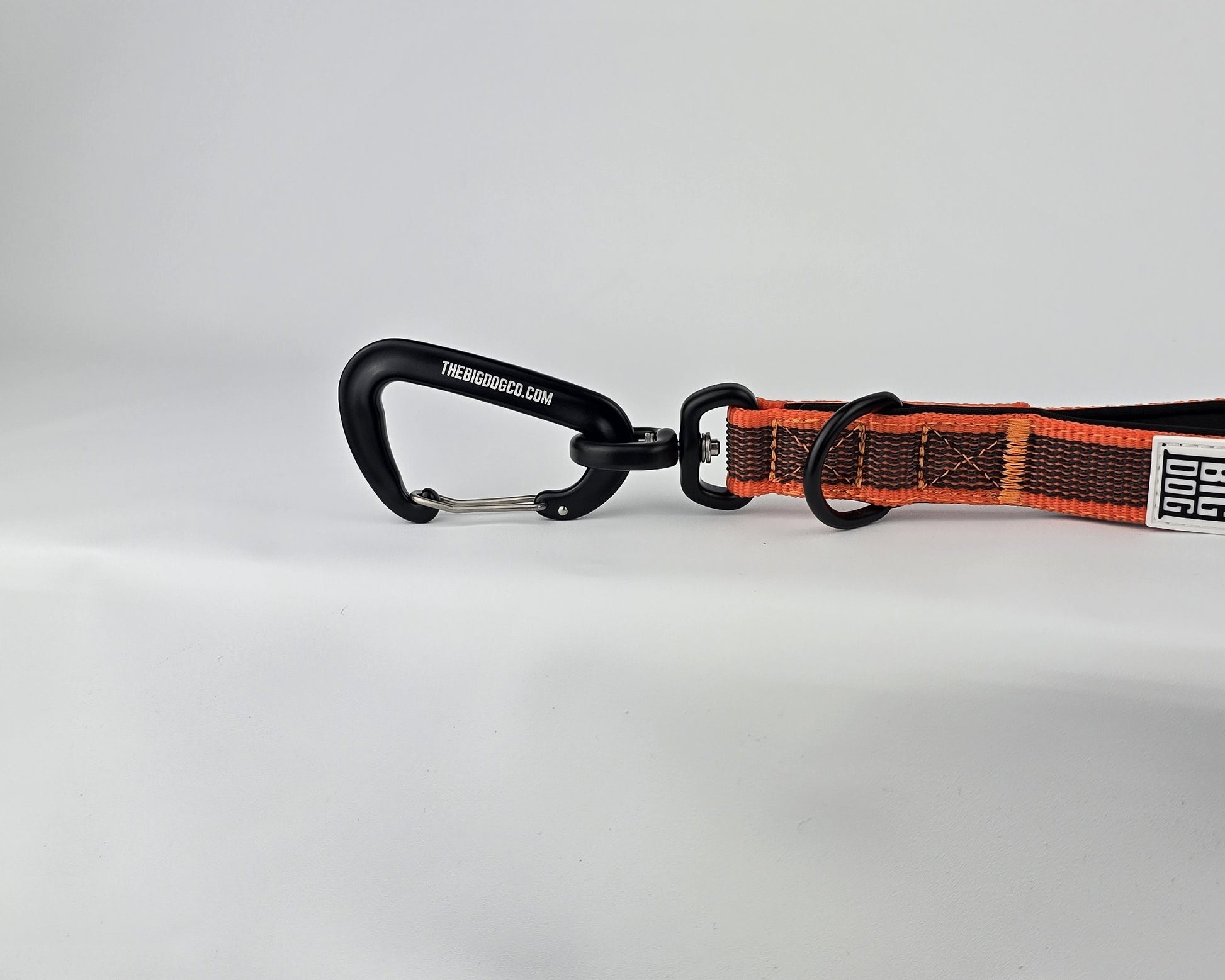 Orange and black dog traffic handle with The Big Dog Company logo on a white background. Heavy duty. Nylon, rubber, neoprene.