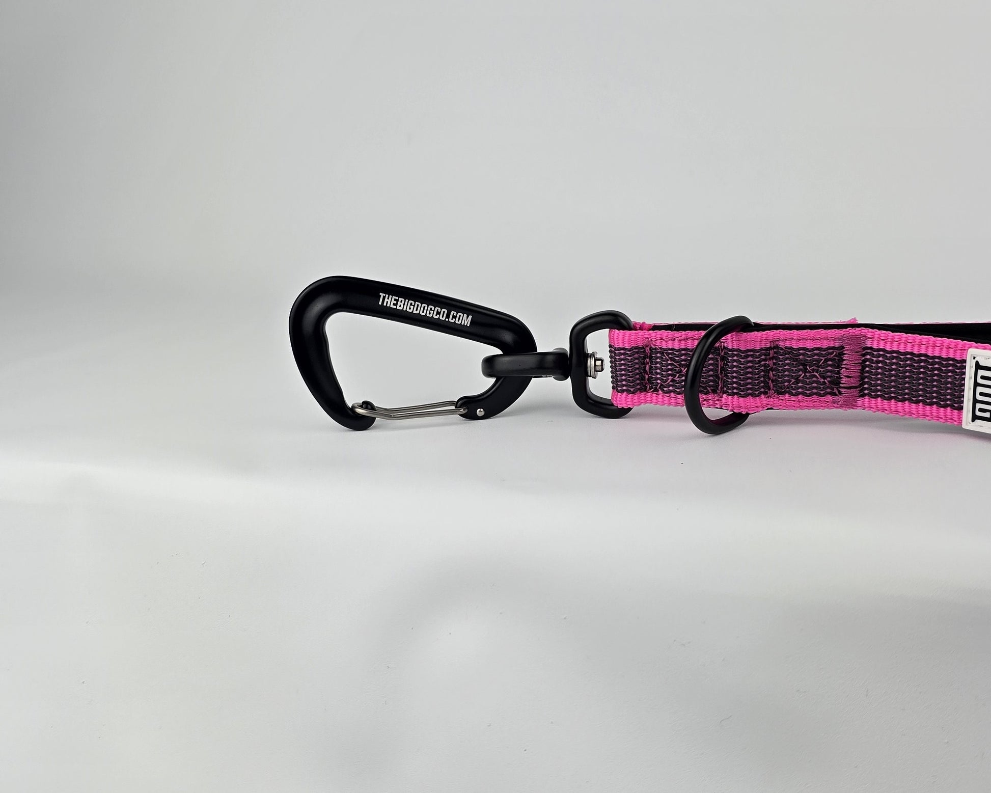 Pink and black dog traffic handle with The Big Dog Company logo on a white background. Heavy duty. Nylon, rubber, neoprene.