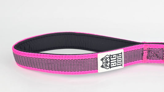 Pink and black dog traffic handle with The Big Dog Company logo on a white background. Heavy duty. Nylon, rubber, neoprene.