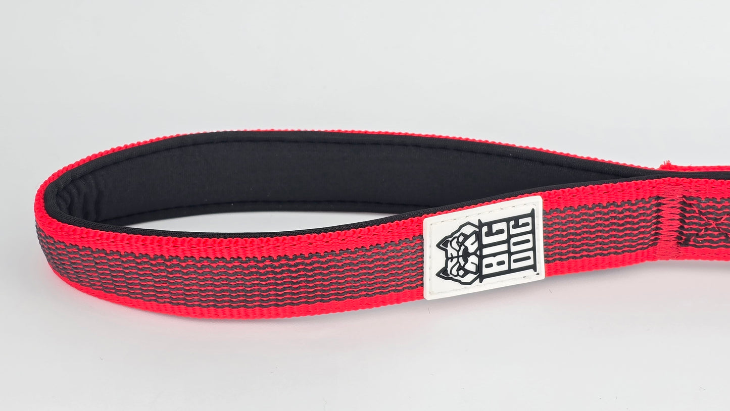 Red and black dog handle with a The Big Dog Company logo. Neoprene, rubber, nylon. Heavy duty, high quality.  