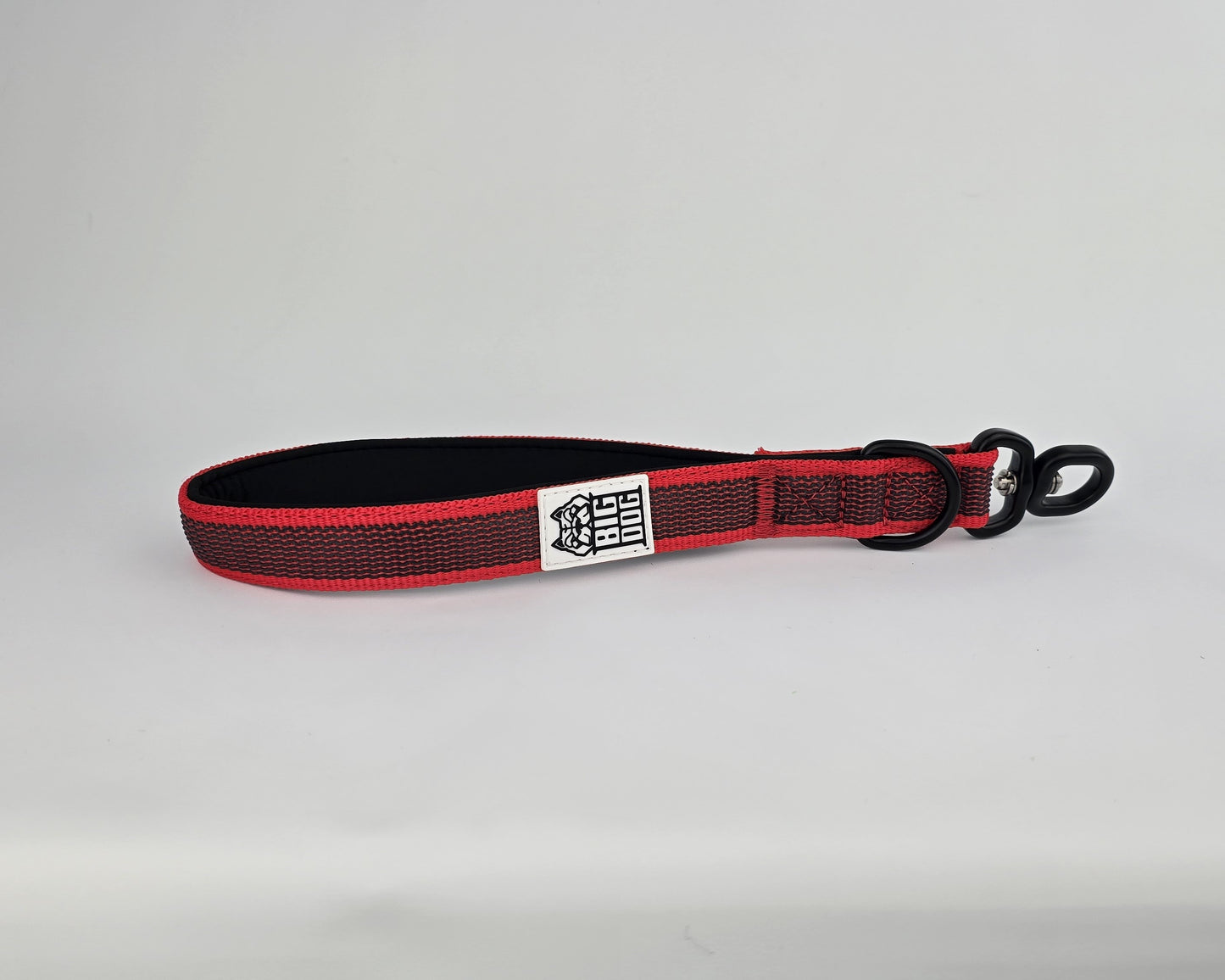 Red and black dog handle with a The Big Dog Company logo. Neoprene, rubber, nylon. Heavy duty, high quality. 