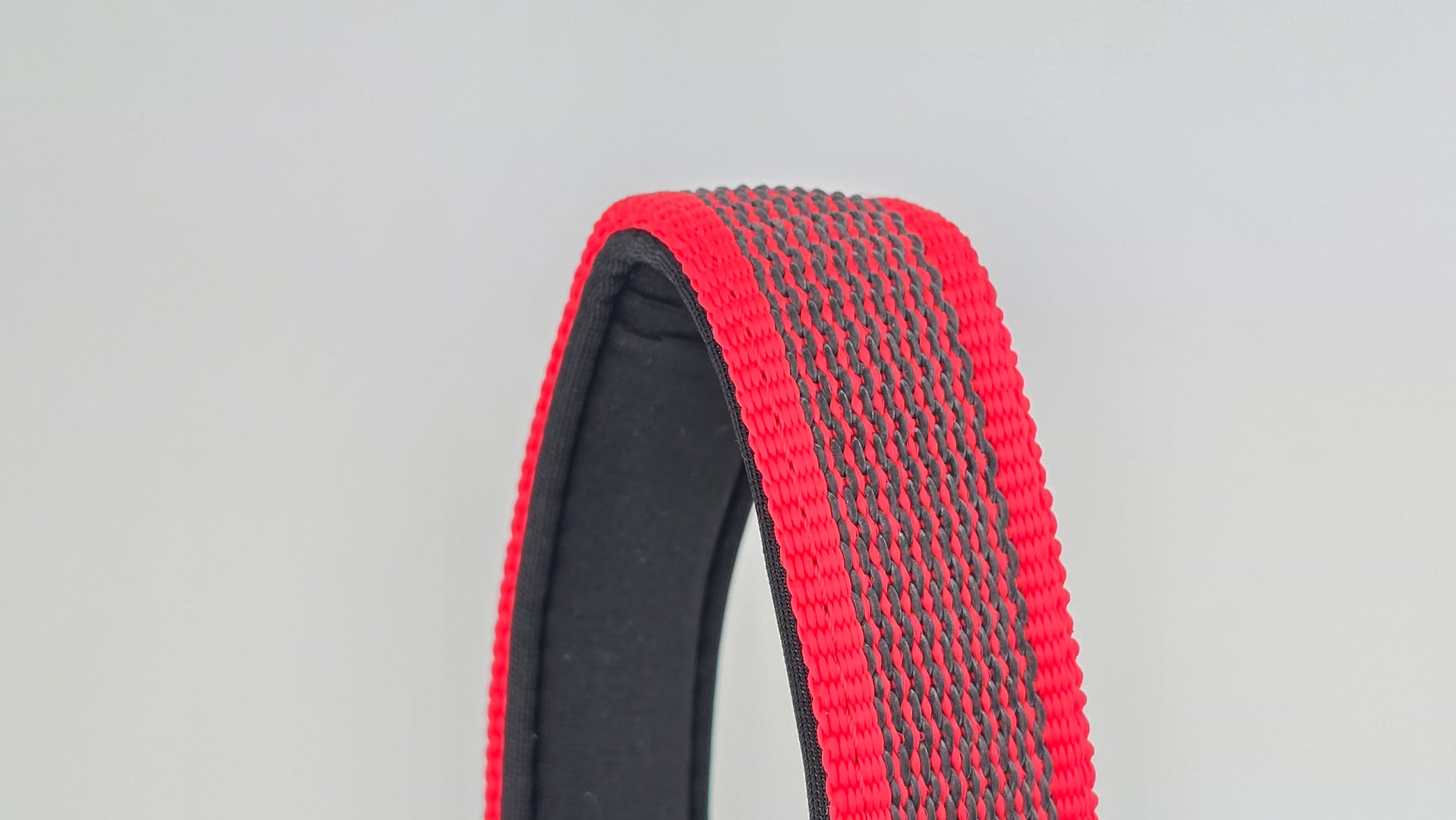 Red and black dog handle with a The Big Dog Company logo. Neoprene, rubber, nylon. Heavy duty, high quality. 