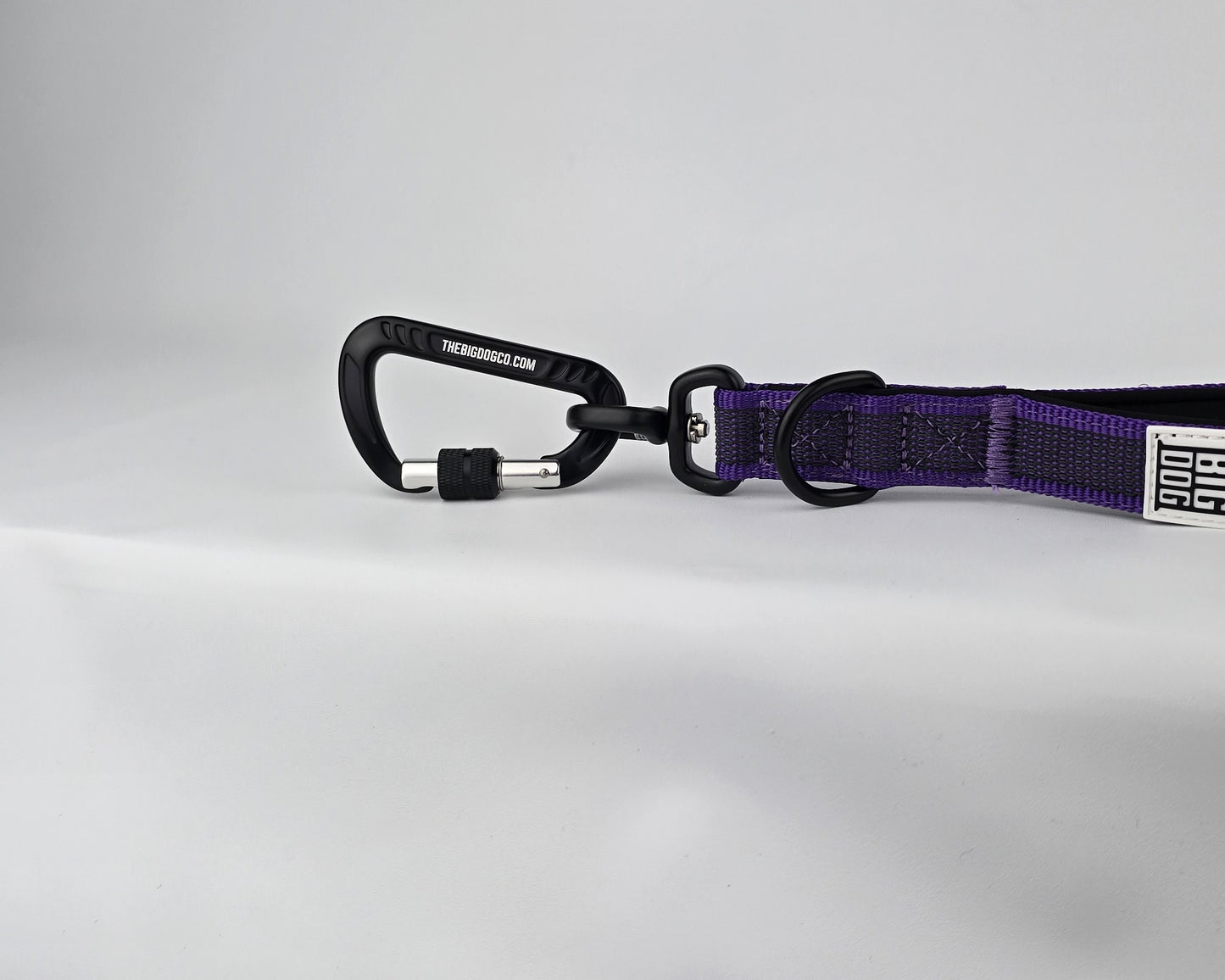 Purple and black dog handle with a The Big Dog Company logo. Neoprene, rubber, nylon. Heavy duty, high quality. 