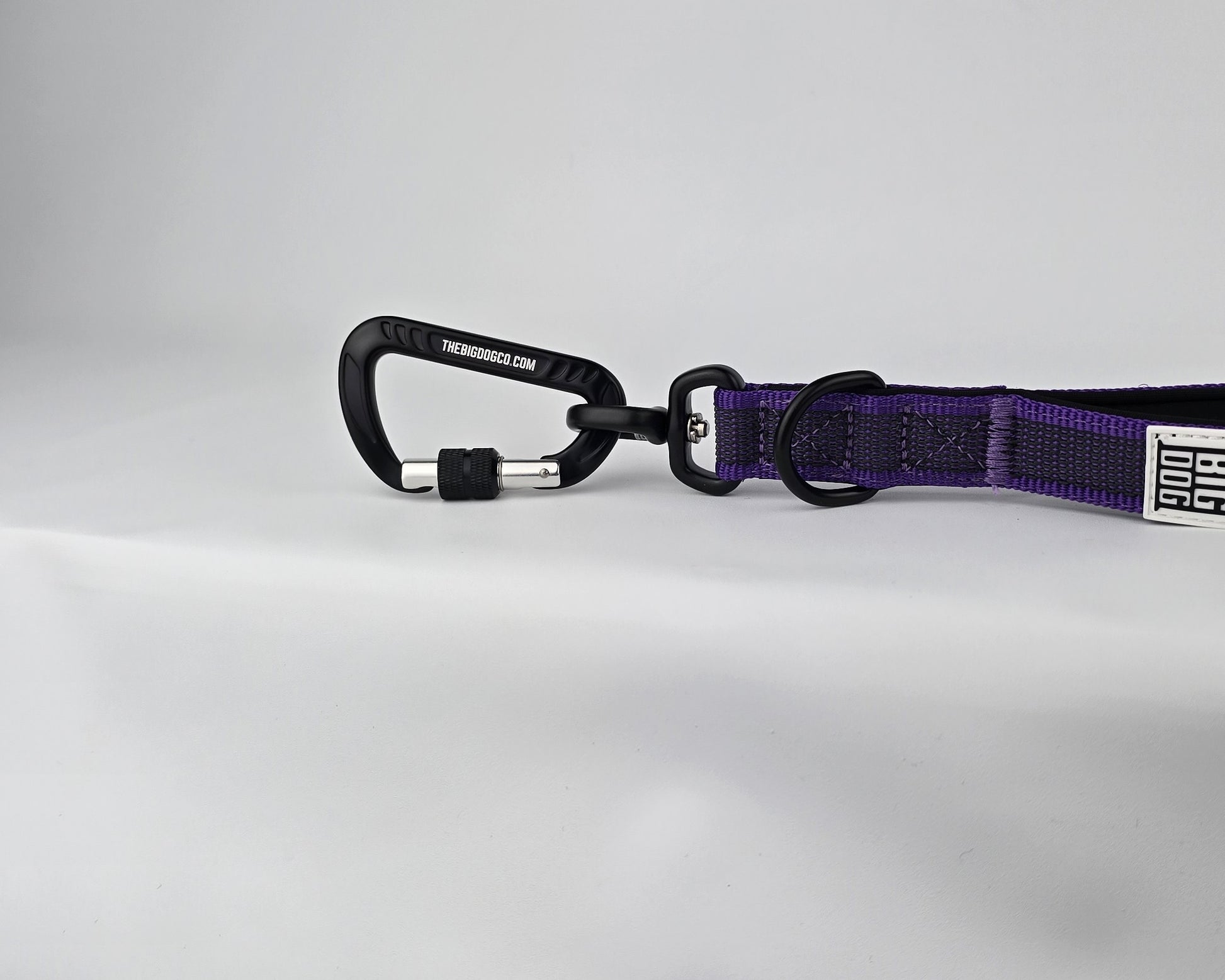 Purple and black dog handle with a The Big Dog Company logo. Neoprene, rubber, nylon. Heavy duty, high quality. 