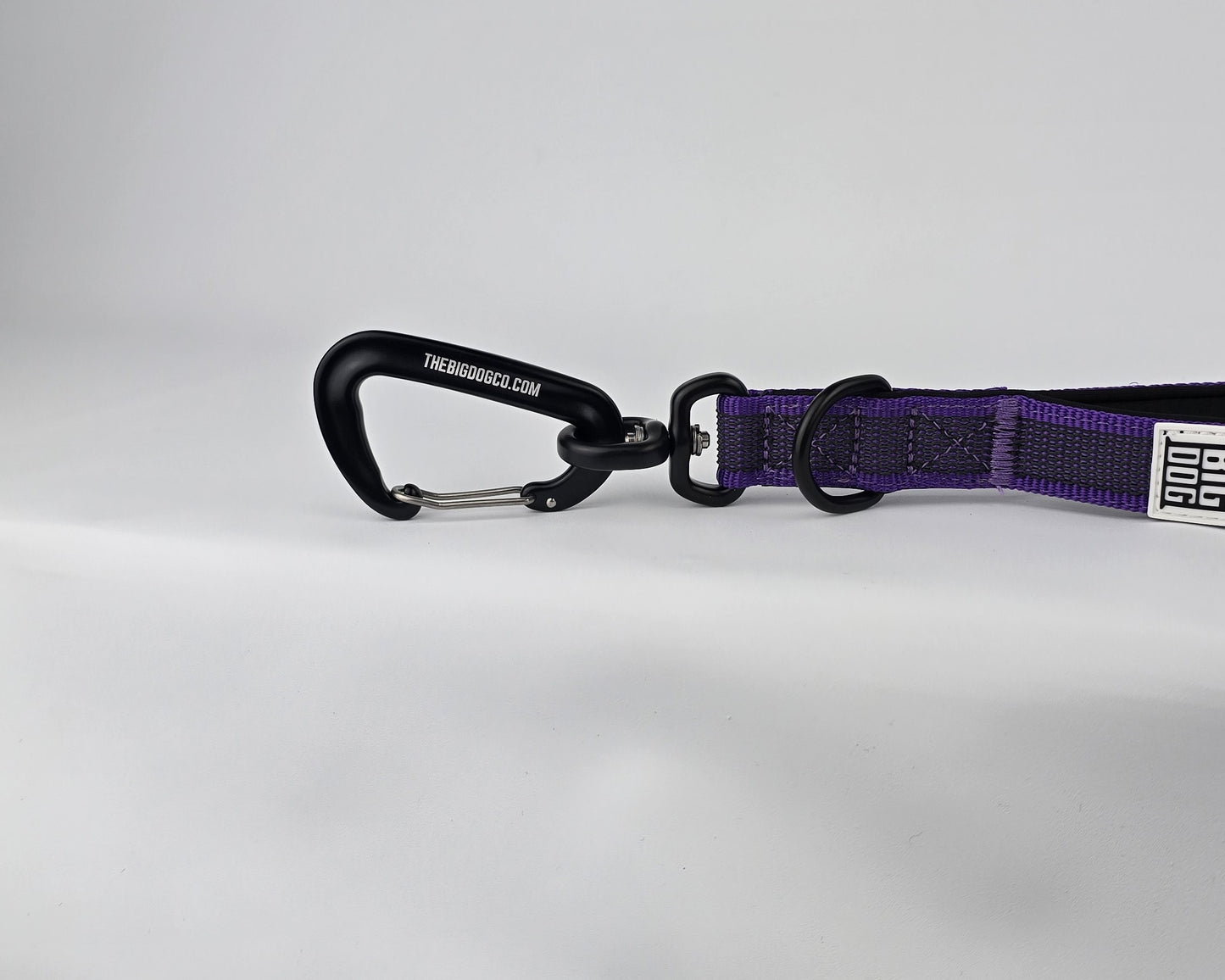 Purple and black dog handle with a The Big Dog Company logo. Neoprene, rubber, nylon. Heavy duty, high quality. 