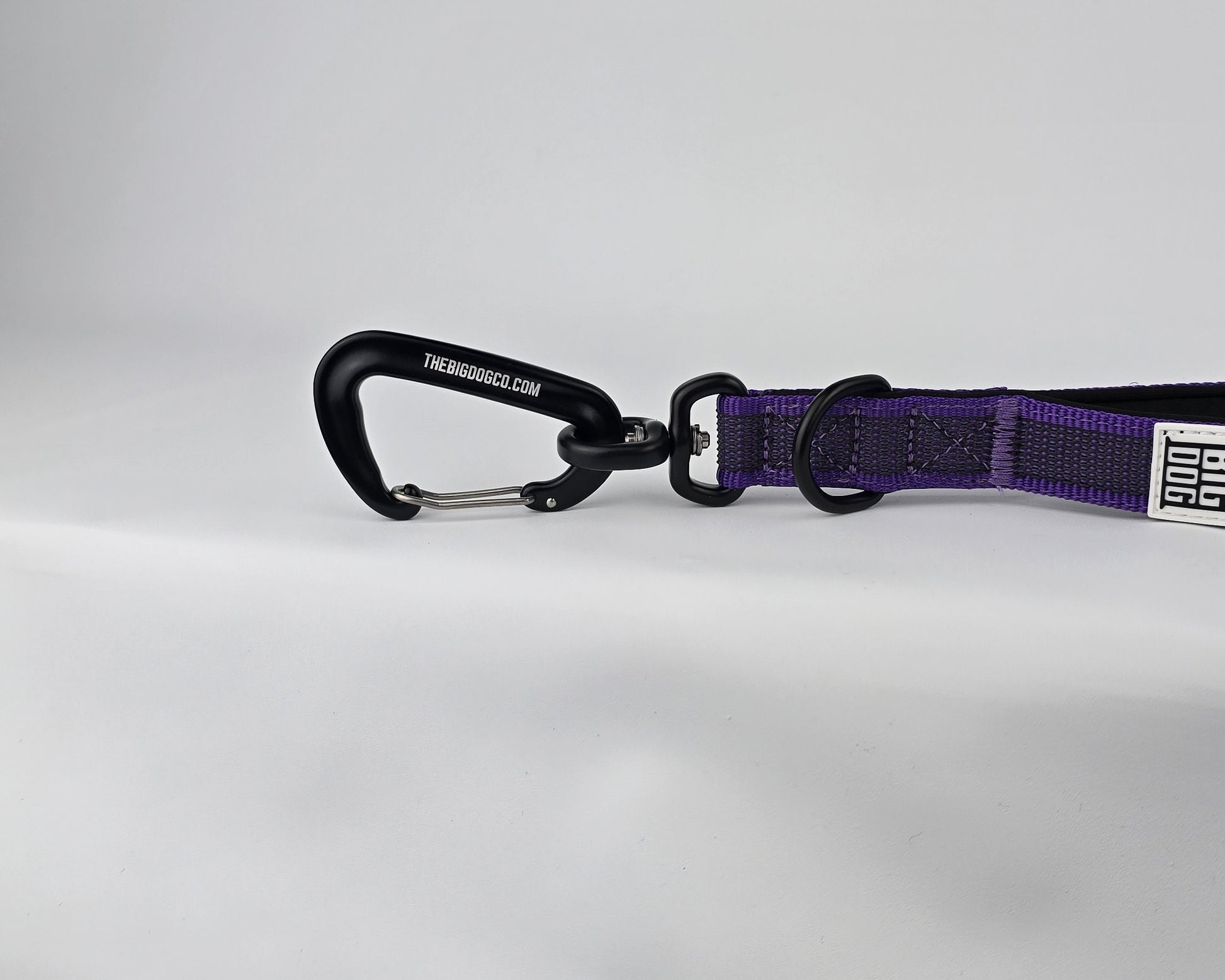 Purple and black dog handle with a The Big Dog Company logo. Neoprene, rubber, nylon. Heavy duty, high quality. 